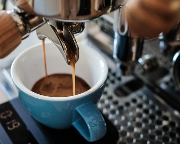 Espresso pouring out of a double spout into two cups