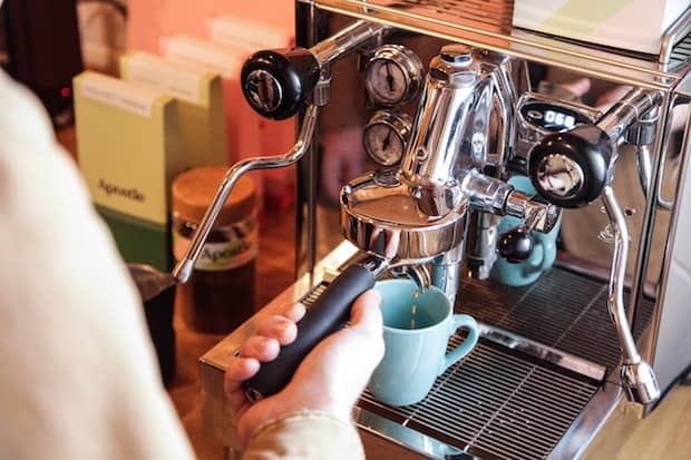 Man pulling a shot with a high-end home espresso machine