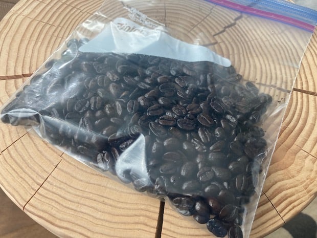 Ziploc bag full of coffee beans on a coffee table