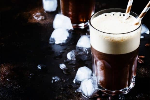 An iced coffee topped with cold foam