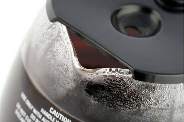 Closeup of the pour spout on a glass coffee carafe