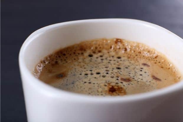 Closeup of the surface of a cup of white coffee