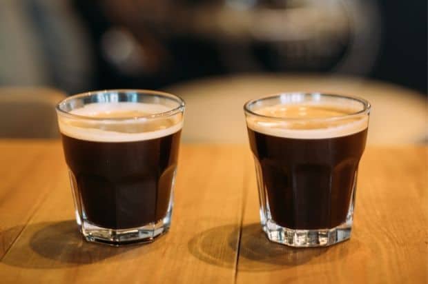Two lungo espressos side by side in clear glasses