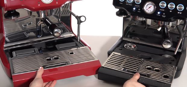 Person removing drip trays from Breville espresso machines to clean