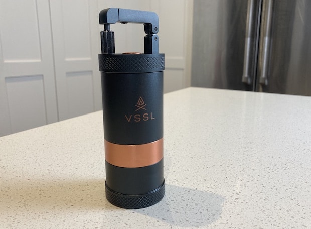 VSSL Java travel coffee grinder on a counter with its handle closed