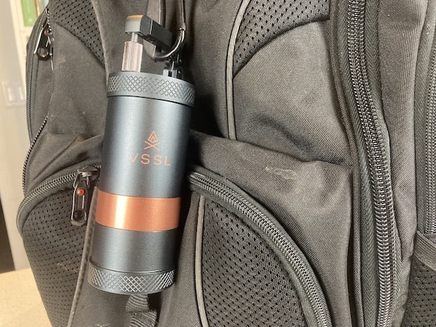 VSSL Java travel coffee grinder attached to backpack