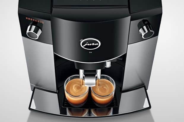 Espresso machine pouring out espresso in a Jura vs. De'Longhi comparison