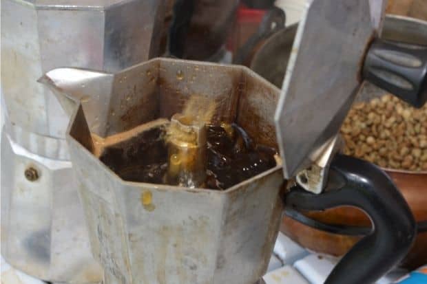 Boiling coffee in moka pot that was sputtering