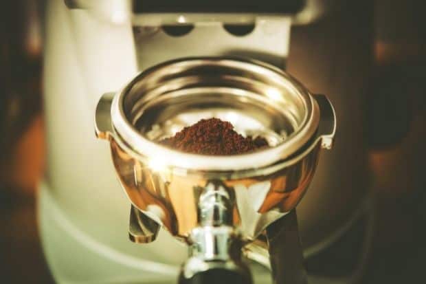 Portafilter with coffee grounds in test to determine if portafilter size does matter