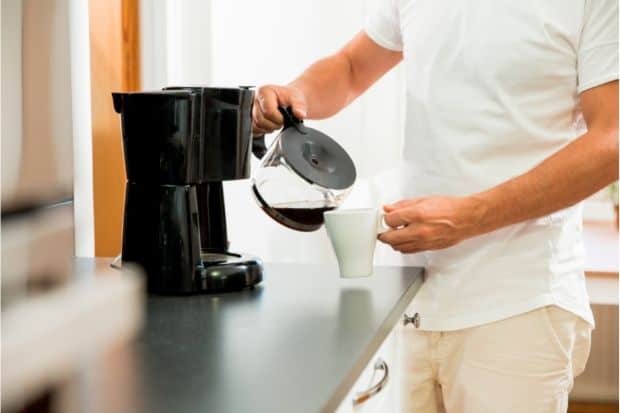 Man pouring from coffee pot that's been sitting out for a long time