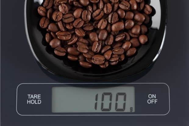 Coffee beans on a kitchen scale that was purchased after brewer learned how to get into coffee