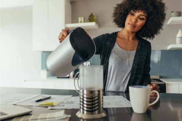 Woman making her own coffee after learning how to get into coffee