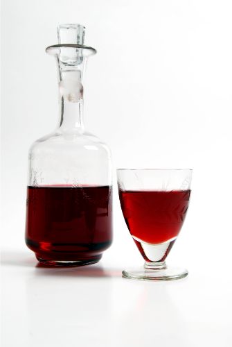Bottle and glass of amaretto liqueur that can work as a liquor for coffee