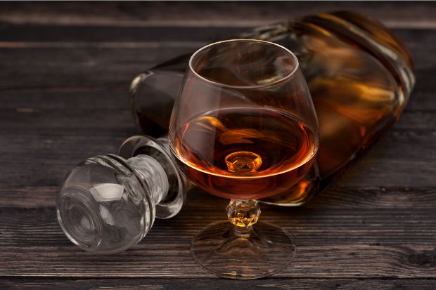 Glass of cognac that works as a liquor for coffee