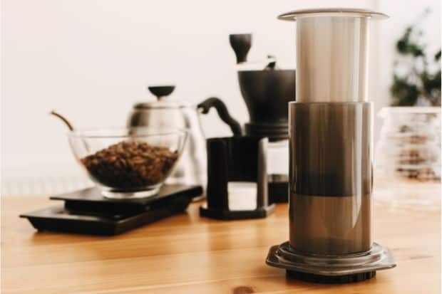 Kettle, coffee beans, and scale next to AeroPress that's ready for inverted method