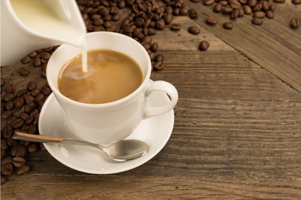 Evaporated milk being poured in coffee