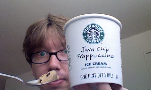 Man holding up container and scoop of Java Chip Frappuccino ice cream from Starbucks after learning what java chips are