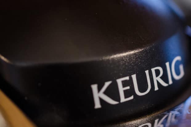 Closeup of Keurig branding on a coffee machine that's not pumping water