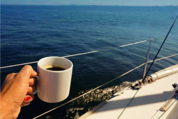 Person enjoying cup of coffee on a boat