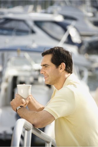 Man enjoying cup of coffee on a boat