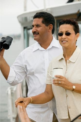 Couple enjoying coffee on a boat after using one of the best coffee makers for boats