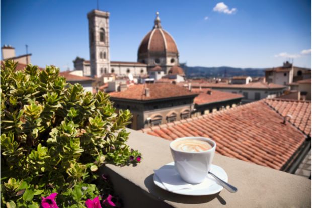 Cup of espresso coffee on balcony outside in Italy