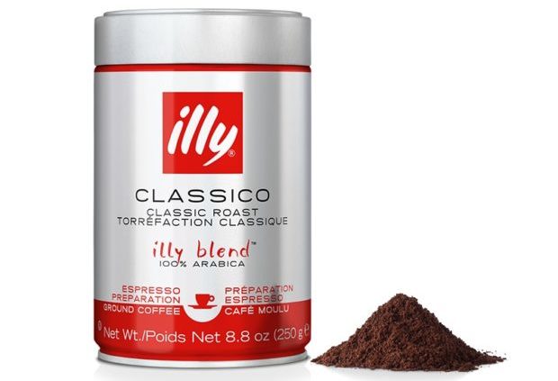 Container of Classico Illy coffee next to a small mound of coffee grounds