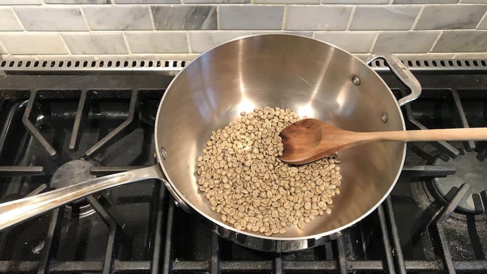 Coffee roasting in a wok on the stove