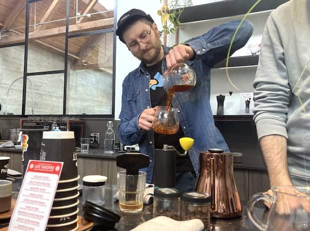 Rafal Walczak behind bar at Pallet Coffee Roasters during the 2022 World AeroPress Championship weekend in Vancouver.