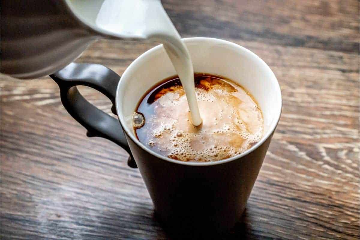 Heavy cream being poured into coffee