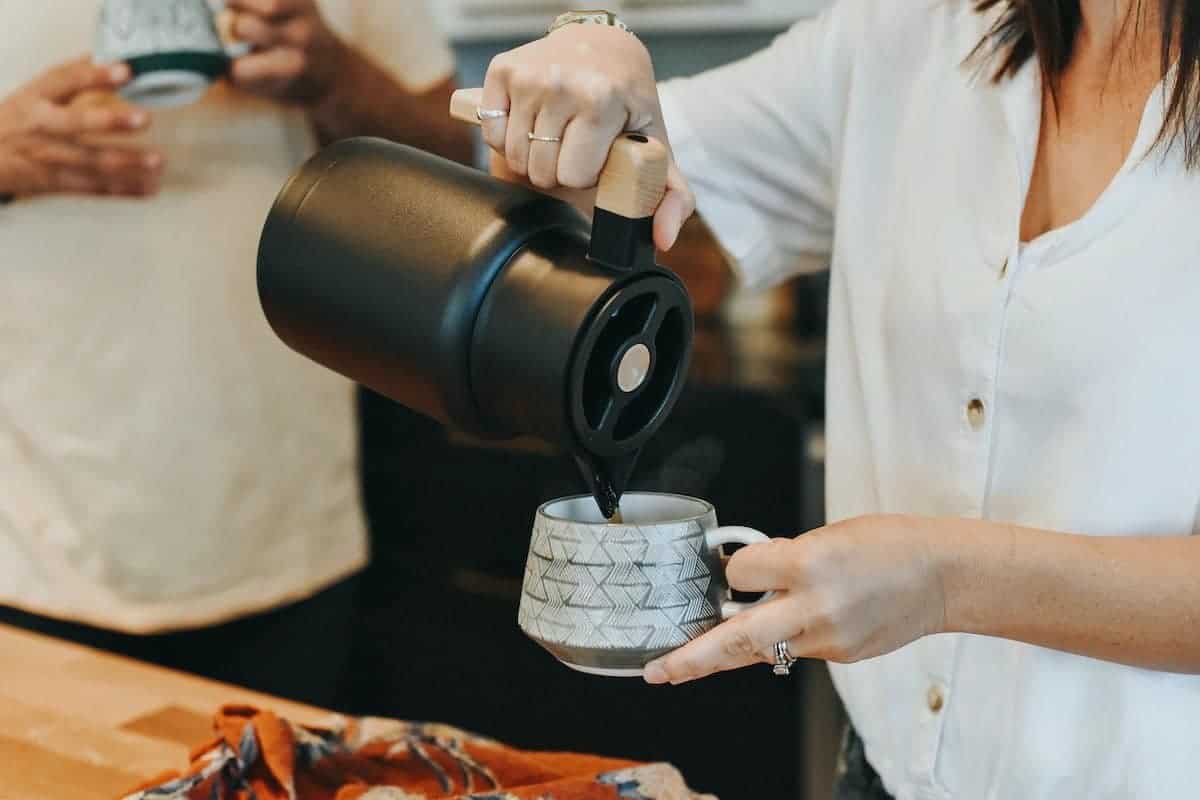 Woman pouring coffee from Hastings Collective carafe