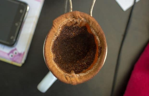 Ground coffee in a cheesecloth filter