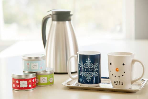 Coffee mugs with a stainless steel thermal carafe in the background