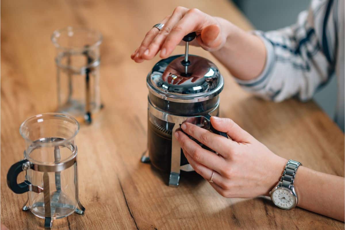 Woman plunging a French press