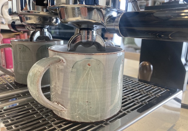Three-inch coffee mug underneath the pour spout of the Diletta Mio's portafilter