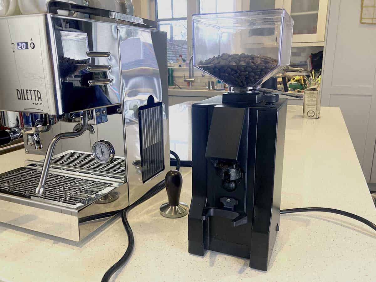 high quality burr grinder next to espresso machine on kitchen counter