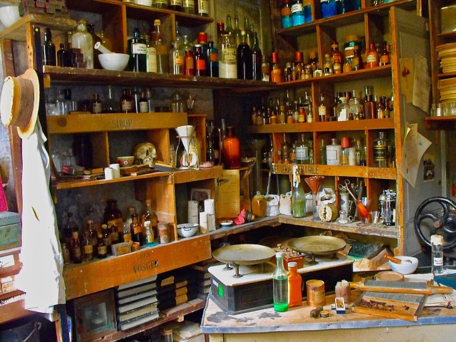 Shelves full of gadgets and bottles at the Musée Alphonse Allais in Honfleur, France.