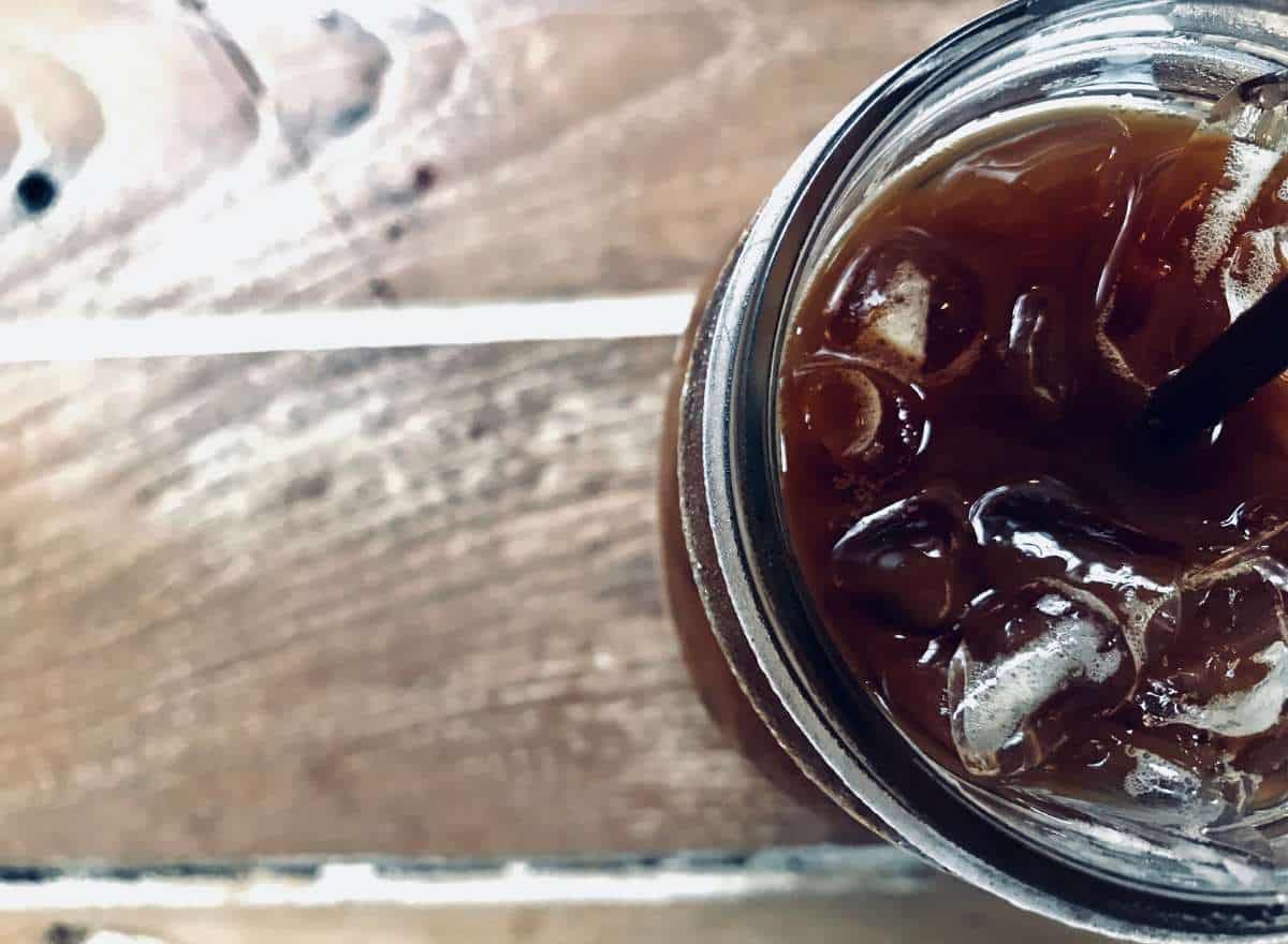 Top view looking into a glass of cold brew coffee with ice cubes