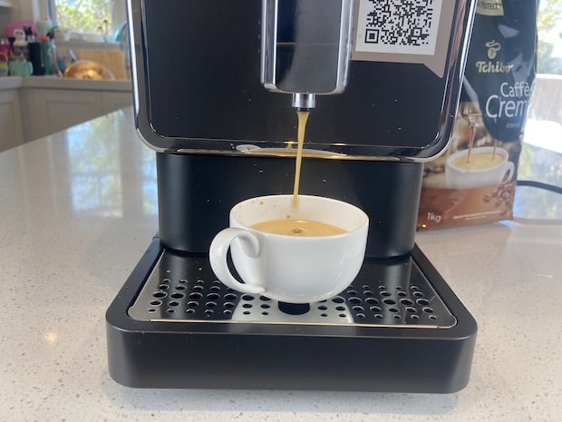 Tchibo coffee machine dispensing espresso into a cup