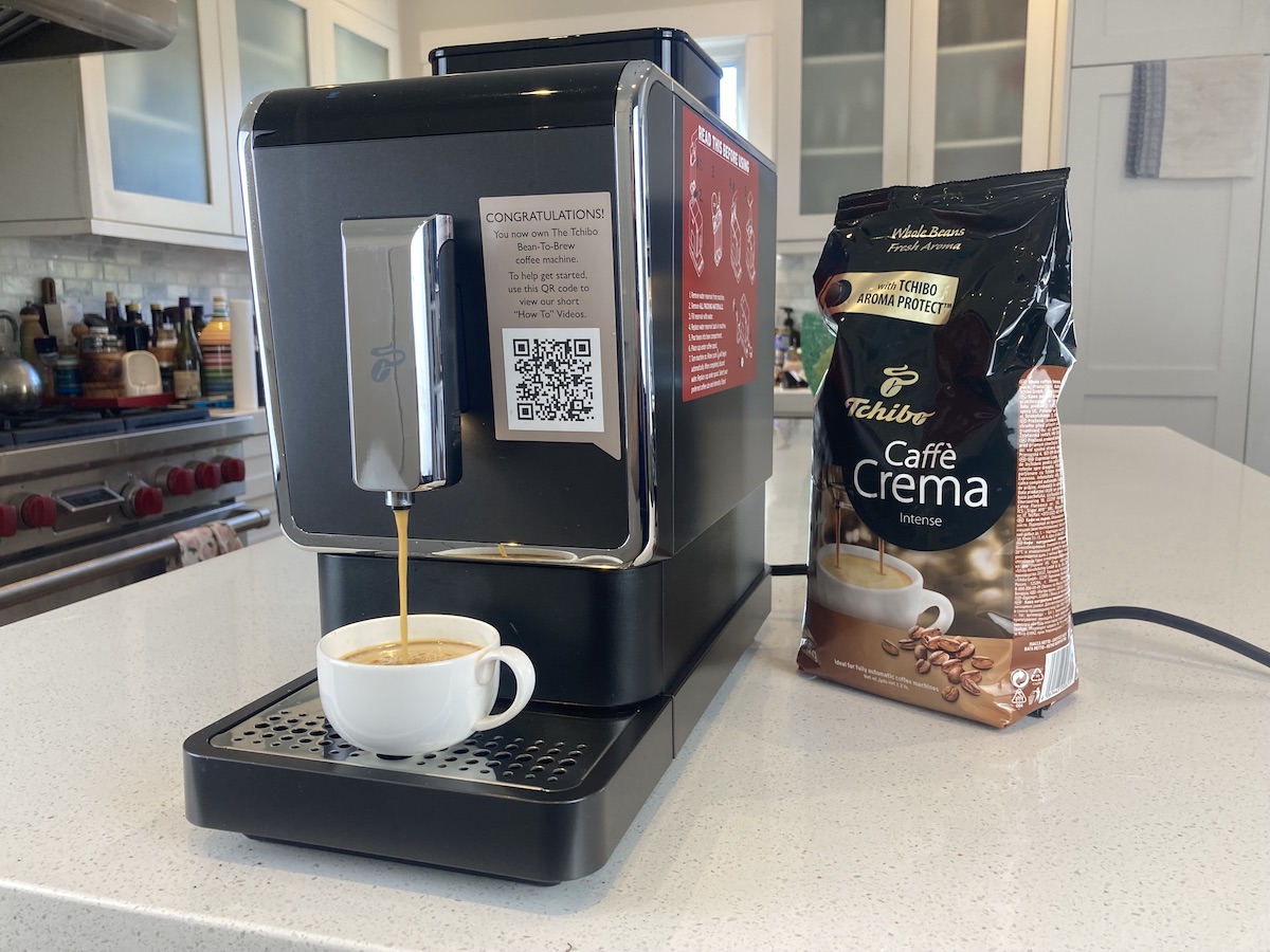 Tchibo Bean-To-Brew Coffee Machine on a kitchen counter next to a bag of beans