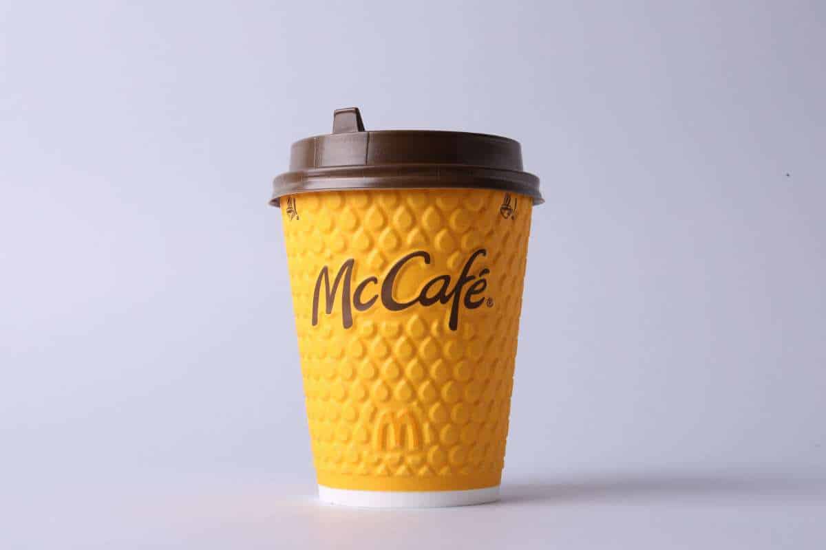 Takeout coffee cup with McCafe written on it.