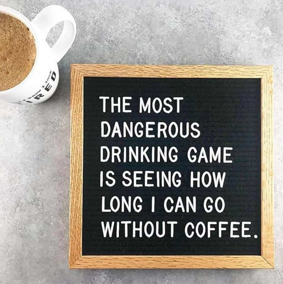 Coffee cup next to a sign that says: The most dangerous drinking game is seeing how long I can go without coffee.