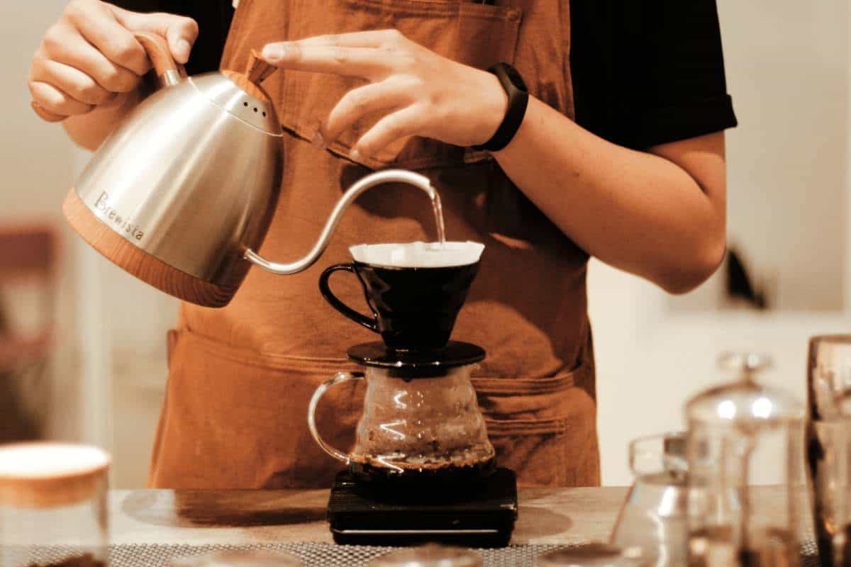 Closeup of a barista making coffee using the pour over method