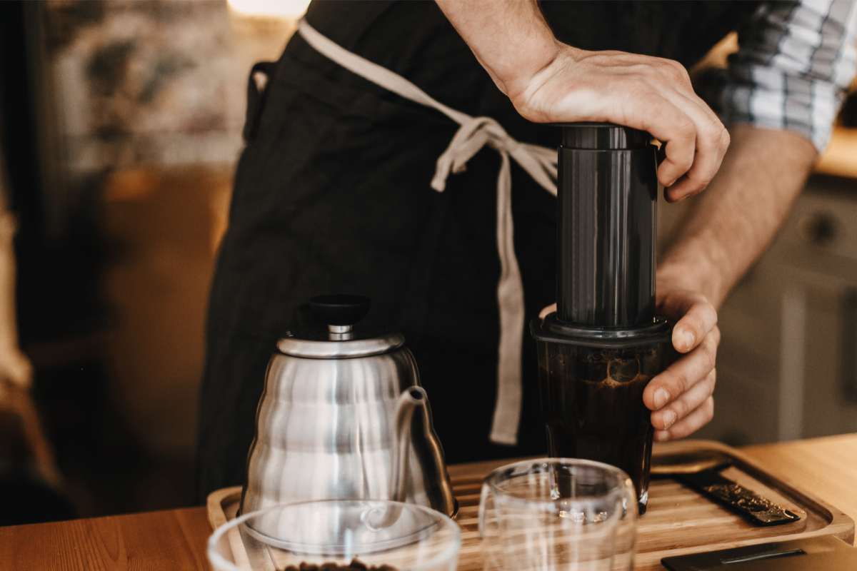 Barista pressing on an AeroPress