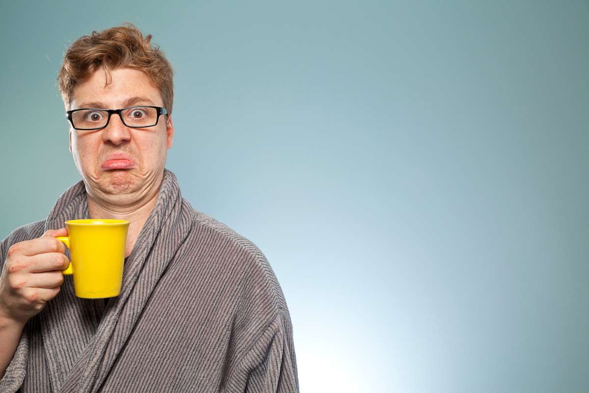 Man reacts to drinking a bad cup of coffee