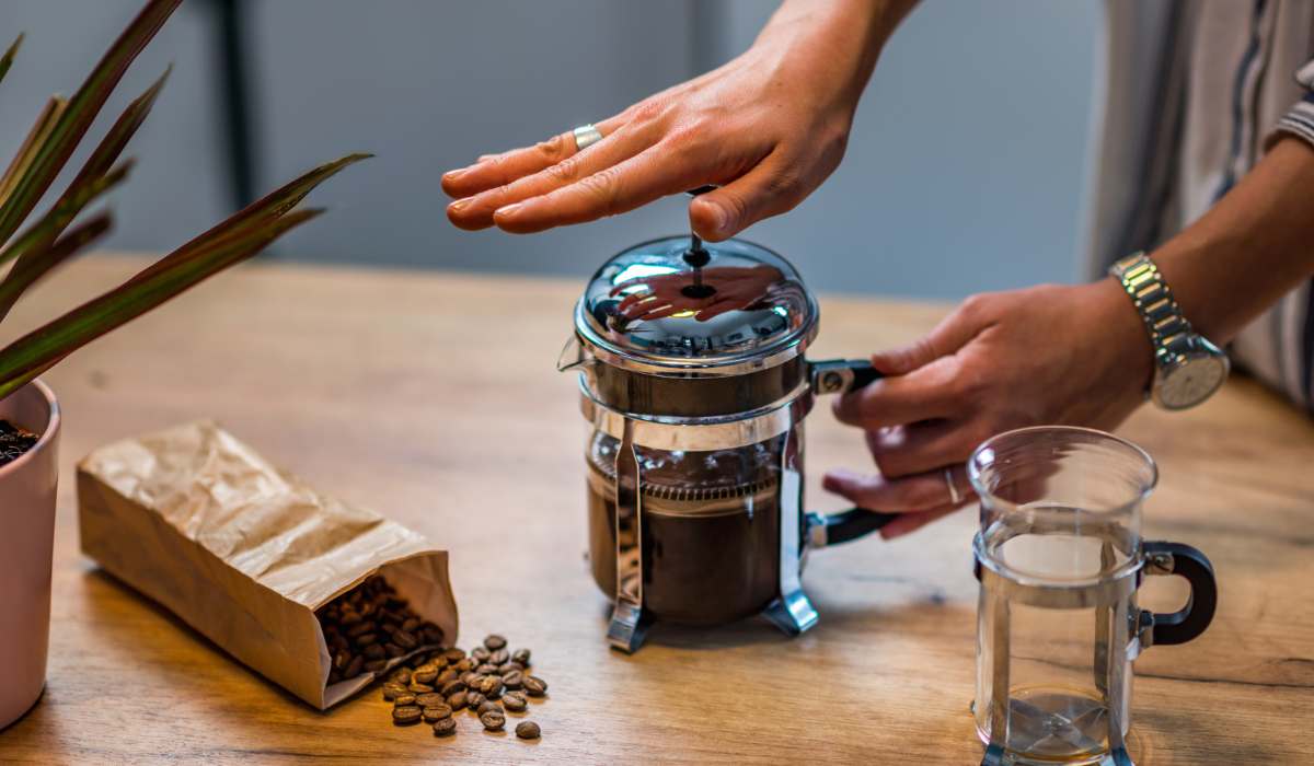 Woman's hand plunging a French press